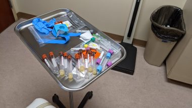 Doctor \ Sarcoidosis News \ A medical tray in a doctor's office with 19 vials and other blood-drawing supplies