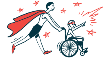 A person wearing a superhero cape pushes a child in a wheelchair.