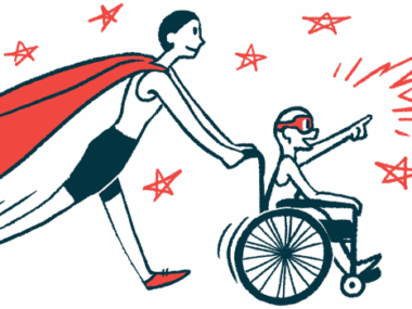 A person wearing a superhero cape pushes a child in a wheelchair.
