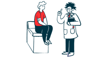 A doctor holding a clipboard gestures to a patient, who is seated on an examining table.