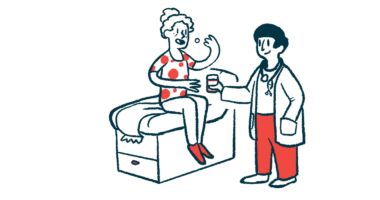 A doctor holds a cup of water as a patient seated on an examination table takes medicine.