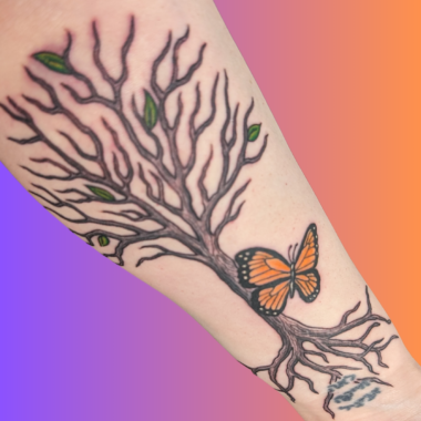 A photo of the author's arm shows a tattoo of a tree with five leaves, roots going through Hebrew lettering, and an orange monarch butterfly in front.